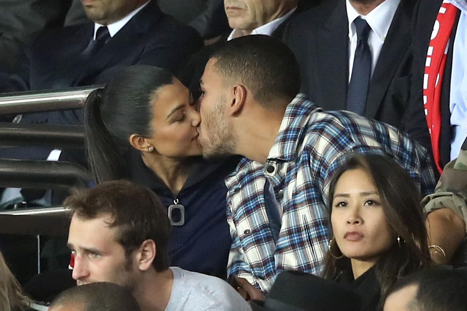Kourtney Kardashian and Boyfriend    Younes Bendjima Share Steamy Kiss at Paris Soccer Game          '  But He Appears    Distracted