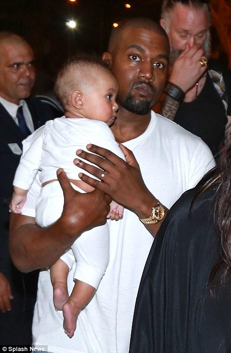 Saint West Cuddles Up To Kanye West As He Joins Kim Kardashian And