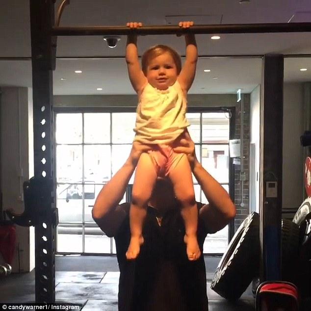 Ivy Mae Warner performs pull ups with a little help from